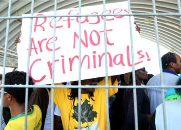 Photo of sign Refugees are not criminals